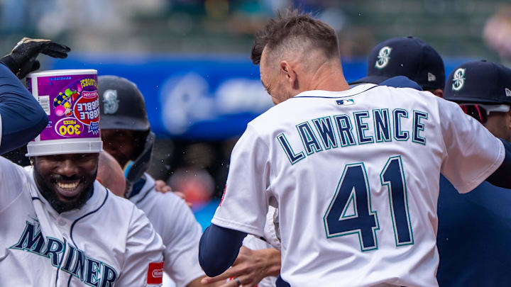 Casey Lawrence helps celebrate a Mariners win on April 9. 
