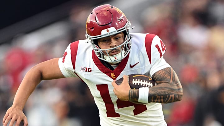 Sep 13, 2025; West Lafayette, Indiana, USA; USC Trojans quarterback Jayden Maiava (14) is tackled by Purdue Boilermakers defensive back Hudauri Hines (4) during the second quarter at Ross-Ade Stadium. Mandatory Credit: Marc Lebryk-Imagn Images