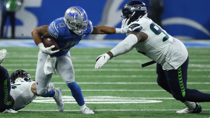 Detroit Lions running back Craig Reynolds (13) is tackled by Seattle Seahawks defensive tackle Cameron Young (93) during second-half action Sunday, Sept.17 2023.