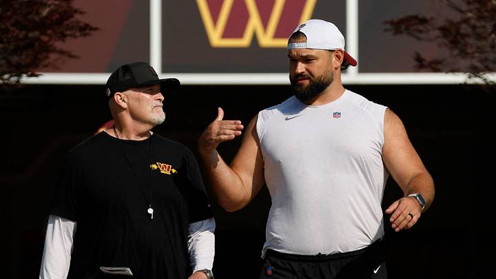 Ashburn, VA, USA; Washington Commanders head coach Dan Quinn (L) talks with Commanders guard Sam Cosmi (R) while walking to the practice fields at the OrthoVirginia Training Center at Commanders Park. Mandatory Credit: Geoff Burke-Imagn Images Ashburn, VA, USA; Washington Commanders head coach Dan Quinn (L) talks with Commanders guard Sam Cosmi (R) while walking to the practice fields at the OrthoVirginia Training Center at Commanders Park. Mandatory Credit: Geoff Burke-Imagn Images