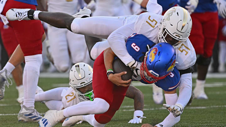 UCF Knights defensive end Malachi Lawrence (51) tackles Kansas Jayhawks quarterback Jason Bean (9)