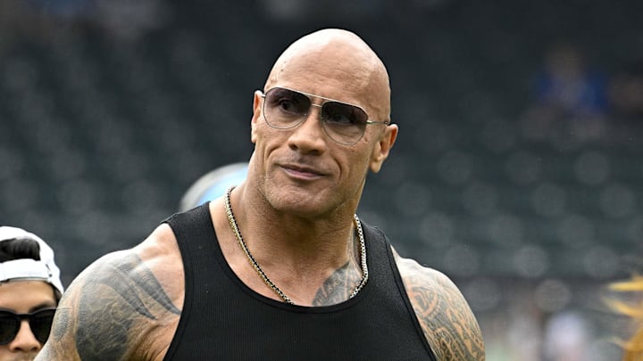Mar 30, 2024; Arlington, TX, USA; UFL owner Dwayne Johnson aka The Rock walks off the field before the game between the Arlington Renegades and the Birmingham Stallions at Choctaw Stadium. Mandatory Credit: Jerome Miron-Imagn Images