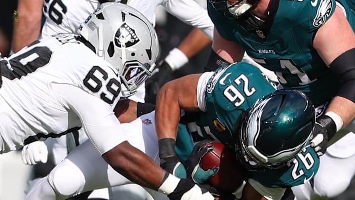 Dec 14, 2025; Philadelphia, Pennsylvania, USA; Philadelphia Eagles running back Saquon Barkley (26) is tackled by Las Vegas Raiders defensive tackle Adam Butler (69) during the first quarter at Lincoln Financial Field. Mandatory Credit: Bill Streicher-Imagn Images Dec 14, 2025; Philadelphia, Pennsylvania, USA; Philadelphia Eagles running back Saquon Barkley (26) is tackled by Las Vegas Raiders defensive tackle Adam Butler (69) during the first quarter at Lincoln Financial Field. Mandatory Credit: Bill Streicher-Imagn Images