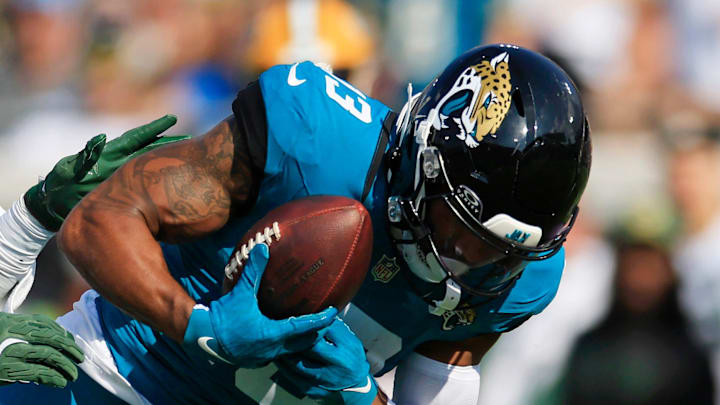 Green Bay Packers linebacker Edgerrin Cooper (56) tackles Jacksonville Jaguars wide receiver Christian Kirk (13) who can’t hang on to a pass and was apparently injured on the play and had to leave the game during the fourth quarter of an NFL football matchup Sunday, Oct. 27, 2024 at EverBank Stadium in Jacksonville, Fla. The Packers edged the Jaguars 30-27 on a last-second field goal. [Corey Perrine/Florida Times-Union]