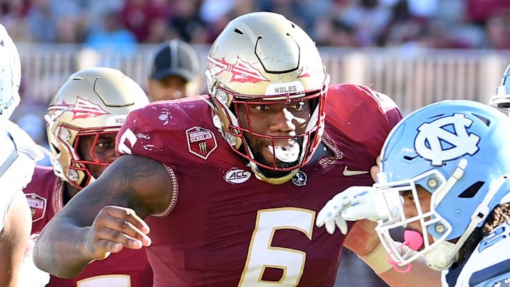 Nov 2, 2024; Tallahassee, Florida, USA;  Florida State Seminoles defensive tackle Darrell Jackson Jr (6) pursues North Carolina Tarheels running back Davion Gause (21) in the second quarter at Doak S. Campbell Stadium. Mandatory Credit: Robert Myers-Imagn Images
