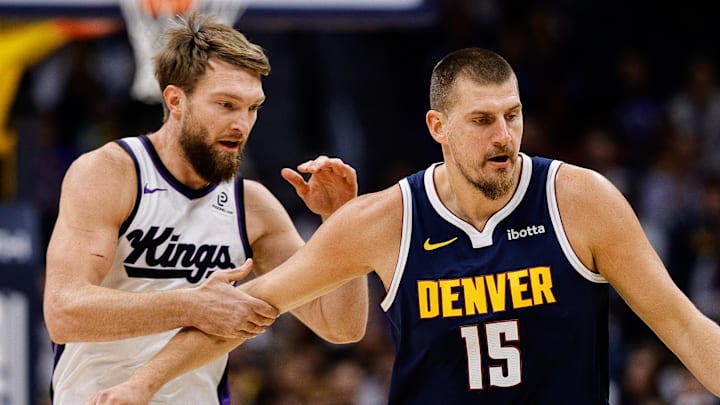 Nov 3, 2025; Denver, Colorado, USA; Denver Nuggets center Nikola Jokic (15) dribbles the ball up court as Sacramento Kings forward Domantas Sabonis (11) defends in the first quarter at Ball Arena. Mandatory Credit: Isaiah J. Downing-Imagn Images