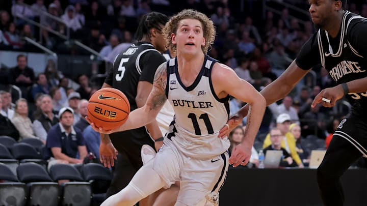 Mar 11, 2026; New York, NY, USA; Butler Bulldogs guard Finley Bizjack (11) drives to the basket against Providence Friars forward Oswin Erhunmwunse (55) during the second half at Madison Square Garden. Mandatory Credit: Brad Penner-Imagn Images