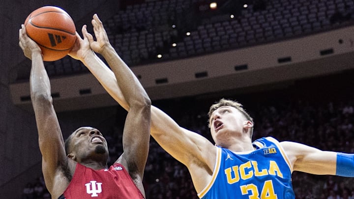 Feb 14, 2025; Bloomington, Indiana, USA; Indiana Hoosiers forward Mackenzie Mgbako (21) shoots the ball while UCLA Bruins forward Tyler Bilodeau (34) defends in the first half at Simon Skjodt Assembly Hall. Mandatory Credit: Trevor Ruszkowski-Imagn Images