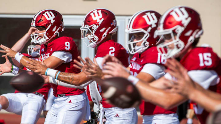 Indiana's Kurtis Rourke (9), Tayven Jackson (2), Alberto Mendoza (16) and Tyler Cherry (15) warm-up before the start of the Indiana versus Charlotte football game at Memorial Stadium on Saturday, Sept. 21, 2024.