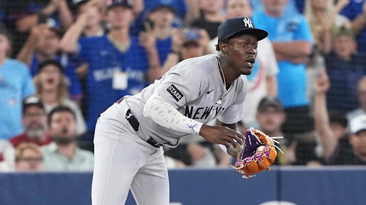 Toronto Blue Jays outfielder George Springer (4) grabs his throat after being tagged out at third base by New York Yankees third baseman Jazz Chisholm Jr. (13) during the sixth inning at Rogers Centre on June 30. Toronto Blue Jays outfielder George Springer (4) grabs his throat after being tagged out at third base by New York Yankees third baseman Jazz Chisholm Jr. (13) during the sixth inning at Rogers Centre on June 30.