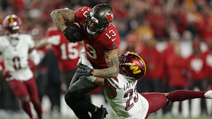 Jan 12, 2025; Tampa, Florida, USA; Tampa Bay Buccaneers wide receiver Mike Evans (13) is tackled by Washington Commanders cornerback Marshon Lattimore (23) during the second quarter of a NFC wild card playoff at Raymond James Stadium. Mandatory Credit: Nathan Ray Seebeck-Imagn Images Jan 12, 2025; Tampa, Florida, USA; Tampa Bay Buccaneers wide receiver Mike Evans (13) is tackled by Washington Commanders cornerback Marshon Lattimore (23) during the second quarter of a NFC wild card playoff at Raymond James Stadium. Mandatory Credit: Nathan Ray Seebeck-Imagn Images