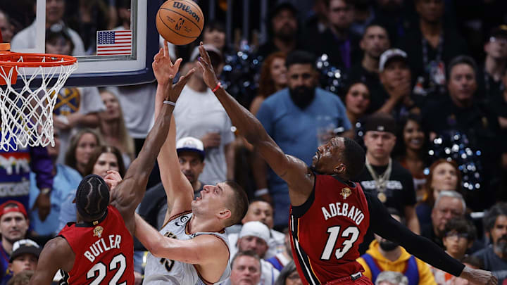 Jun 12, 2023; Denver, Colorado, USA; Denver Nuggets center Nikola Jokic (15) battles for a rebound against Miami Heat forward Jimmy Butler (22) and center Bam Adebayo (13) during the third quarter of game five of the 2023 NBA Finals at Ball Arena. Mandatory Credit: Isaiah J. Downing-Imagn Images Jun 12, 2023; Denver, Colorado, USA; Denver Nuggets center Nikola Jokic (15) battles for a rebound against Miami Heat forward Jimmy Butler (22) and center Bam Adebayo (13) during the third quarter of game five of the 2023 NBA Finals at Ball Arena. Mandatory Credit: Isaiah J. Downing-Imagn Images