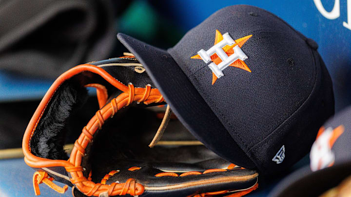 Apr 27, 2025; Kansas City, Missouri, USA; Houston Astros hat and glove in the dugout during the second inning against the Kansas City Royals at Kauffman Stadium. 
