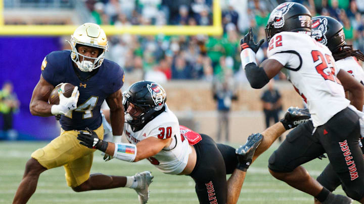 Notre Dame running back Jadarian Price, left, runs with the ball as NC State linebacker Zane Williams (30) chases in the second half of a NCAA football game at Notre Dame Stadium on Saturday, Oct. 11, 2025, in South Bend. Notre Dame running back Jadarian Price, left, runs with the ball as NC State linebacker Zane Williams (30) chases in the second half of a NCAA football game at Notre Dame Stadium on Saturday, Oct. 11, 2025, in South Bend.