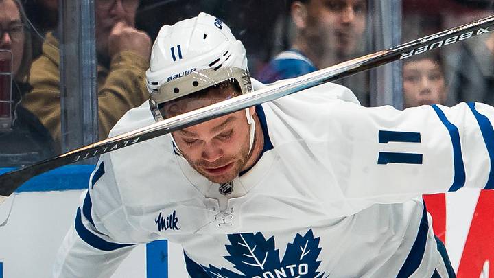 Jan 31, 2026; Vancouver, British Columbia, CAN; Vancouver Canucks defenseman Pierre-Olivier Joseph (7) battles with Toronto Maple Leafs forward Max Domi (11) in the first period at Rogers Arena. Mandatory Credit: Bob Frid-Imagn Images