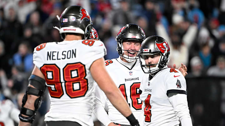 Dec 1, 2024; Charlotte, North Carolina, USA; Tampa Bay Buccaneers place kicker Chase McLaughlin (4) celebrates with linebacker Anthony Nelson (98) and punter Trenton Gill (16) after kicking the game winning field goal in overtime at Bank of America Stadium. Mandatory Credit: Bob Donnan-Imagn Images