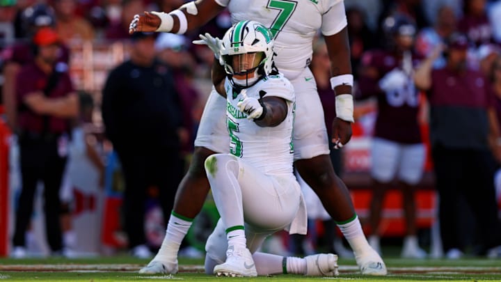 Sep 7, 2024; Blacksburg, Virginia, USA; Marshall Thundering Herd defensive lineman Mike Green (15) celebrates after sacking Virginia Tech Hokies quarterback Kyron Drones (1) during the first quarter at Lane Stadium. Mandatory Credit: Peter Casey-Imagn Images