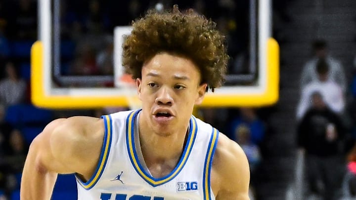 Mar 3, 2026; Los Angeles, California, USA; UCLA Bruins guard Trent Perry (0) drives to the basket as Nebraska Cornhuskersforward Berke Buyuktuncel (9) moves n to defend during the 1st half at Pauley Pavilion presented by Wescom Financial. Mandatory Credit: Robert Hanashiro-Imagn Images