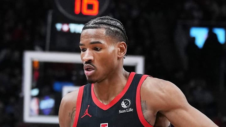 LA Clippers guard James Harden controls the ball as Toronto Raptors guard Ochai Agbaji tries to defend.