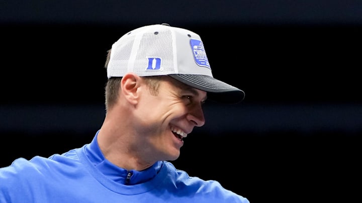 Mar 14, 2026; Charlotte, NC, USA; Duke Blue Devils head coach Jon Scheyer cuts down the net after defeating the Virginia Cavaliers in the men's ACC Conference Tournament Championship at Spectrum Center. Mandatory Credit: Bob Donnan-Imagn Images