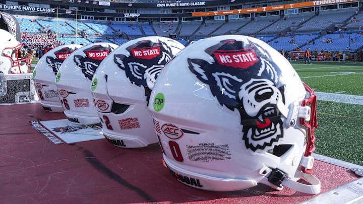 Sep 7, 2024; Charlotte, North Carolina, USA; North Carolina State Wolfpack helmets during pregame activity for the Dukes Mayo Classic against the Tennessee Volunteers at Bank of America Stadium. Mandatory Credit: Jim Dedmon-Imagn Images