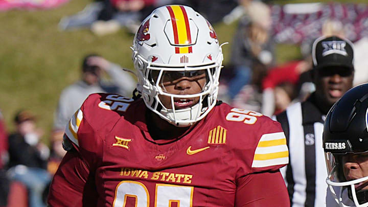 Iowa State Cyclones' defensive back David Coffey (18), defensive line Ikenna Ezeogu (88) and defensive line Domonique Orange (95) takes down Kansas Jayhawks quarterback Isaiah Marshall (8) during the first quarter in the senior day on Nov. 22, 2025, at Jack Trice Stadium in Ames, Iowa