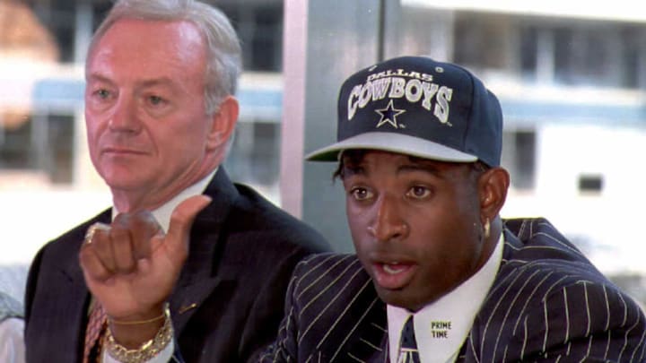 Deion Sanders (R) talks to reporters at a press co
