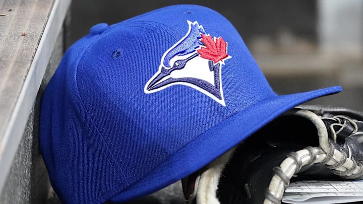 Apr 16, 2025; Toronto, Ontario, CAN; A Toronto Blue Jays hat and glove in the dugout during a game against the Atlanta Braves at Rogers Centre. 
