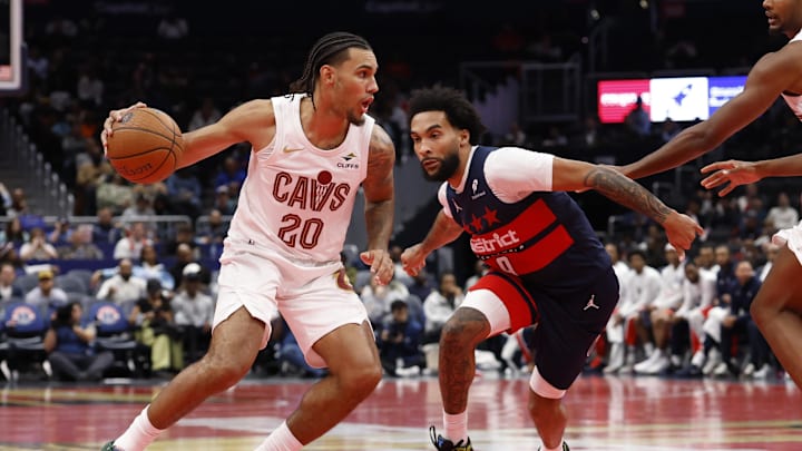 Nov 7, 2025; Washington, District of Columbia, USA; Cleveland Cavaliers guard Jaylon Tyson (20) drives to the basket as Washington Wizards forward Justin Champagnie (9) defends in the second half in an Emirates NBA Cup game at Capital One Arena. Mandatory Credit: Geoff Burke-Imagn Images
