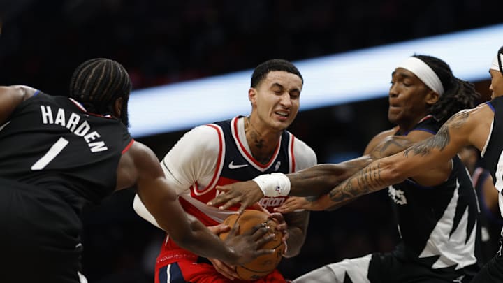 Washington Wizards forward Kyle Kuzma (33) drives to the basket as LA Clippers guards James Harden (1), and Terance Mann (14), defend at Capital One Arena. Washington Wizards forward Kyle Kuzma (33) drives to the basket as LA Clippers guards James Harden (1), and Terance Mann (14), defend at Capital One Arena.