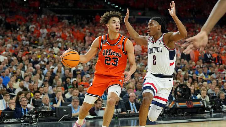Apr 4, 2026; Indianapolis, IN, USA; Illinois Fighting Illini guard Keaton Wagler (23) dribbles the ball against UConn Huskies guard Silas Demary Jr. (2) during the first half of a semifinal of the Final Four of the men's 2026 NCAA Tournament at Lucas Oil Stadium. Mandatory Credit: Bob Donnan-Imagn Images Apr 4, 2026; Indianapolis, IN, USA; Illinois Fighting Illini guard Keaton Wagler (23) dribbles the ball against UConn Huskies guard Silas Demary Jr. (2) during the first half of a semifinal of the Final Four of the men's 2026 NCAA Tournament at Lucas Oil Stadium. Mandatory Credit: Bob Donnan-Imagn Images