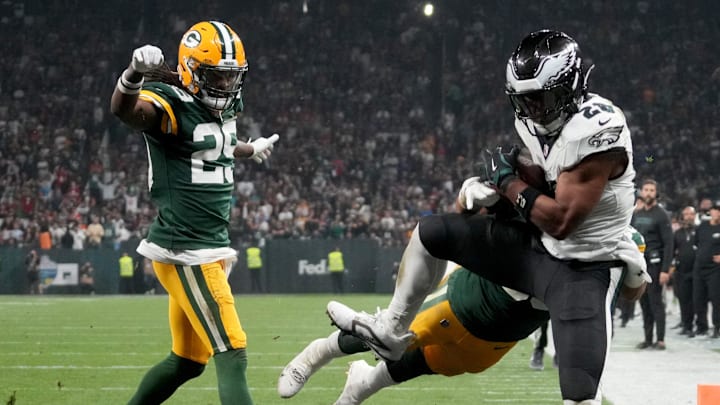 Sep 6, 2024; Sao Paulo, BRA; Philadelphia Eagles running back Saquon Barkley (26) catches a touchdown against Green Bay Packers linebacker Isaiah McDuffie (58) and safety Xavier McKinney (29) during the second quarter at Neo Quimica Arena. Mandatory Credit: Kirby Lee-Imagn Images