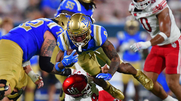 Aug 30, 2025; Pasadena, California, USA; UCLA Bruins quarterback Nico Iamaleava (9) moves the ball against Utah Utes linebacker Lander Barton (8) during the first half at Rose Bowl. Mandatory Credit: Gary A. Vasquez-Imagn Images