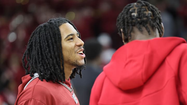 Arkansas Razorbacks guard Boogie Fland talks to forward Adou Thiero prior to the Hogs' last regular season game against the Mississippi State Bulldogs at Bud Walton Arena on March 8. Arkansas is 9-6 since Fland was injured.