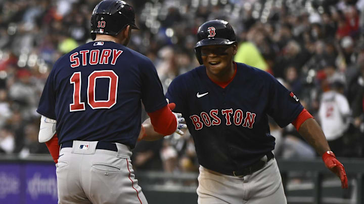 Boston Red Sox second baseman Trevor Story (10), right, celebrates with Boston Red Sox third baseman Rafael Devers, right, after they score on Story's three-run home run during the first inning against the Chicago White Sox at Guaranteed Rate Field.