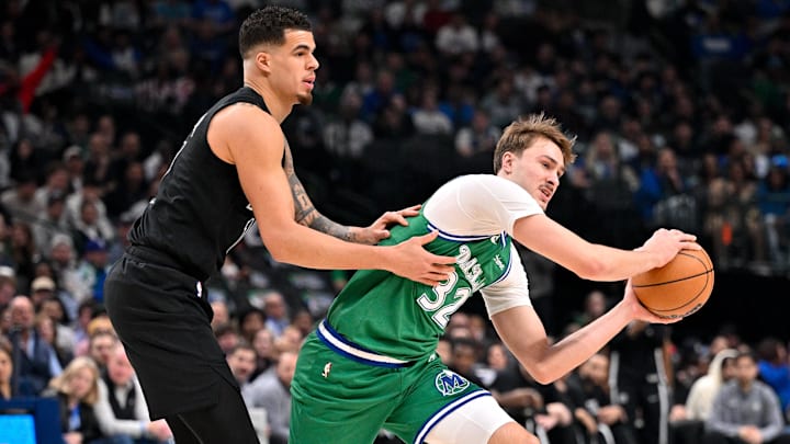 Jan 12, 2026; Dallas, Texas, USA; Dallas Mavericks forward Cooper Flagg (32) looks to move the ball past Brooklyn Nets forward Michael Porter Jr. (17) during the first quarter at the American Airlines Center. Mandatory Credit: Jerome Miron-Imagn Images