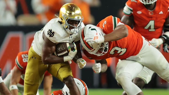 Aug 31, 2025; Miami Gardens, Florida, USA; Notre Dame Fighting Irish running back Jadarian Price (24) rushes the ball past Miami Hurricanes defensive lineman Akheem Mesidor (3) during the second quarter at Hard Rock Stadium. Mandatory Credit: Sam Navarro-Imagn Images Aug 31, 2025; Miami Gardens, Florida, USA; Notre Dame Fighting Irish running back Jadarian Price (24) rushes the ball past Miami Hurricanes defensive lineman Akheem Mesidor (3) during the second quarter at Hard Rock Stadium. Mandatory Credit: Sam Navarro-Imagn Images