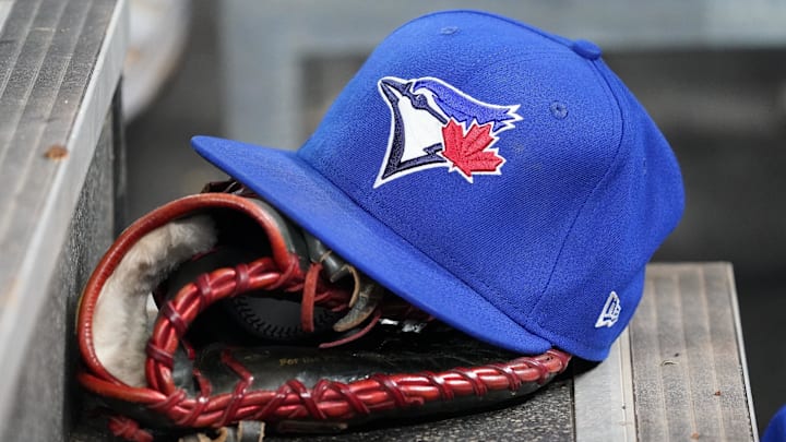 Apr 16, 2025; Toronto, Ontario, CAN; A Toronto Blue Jays hat and glove in the dugout during a game against the Atlanta Braves at Rogers Centre. 