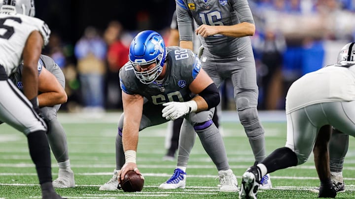 Detroit Lions quarterback Jared Goff (16) talks to guard Graham Glasgow (60) before a snap against