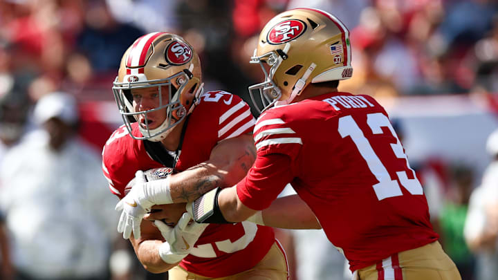 Nov 10, 2024; Tampa, Florida, USA; San Francisco 49ers quarterback Brock Purdy (13) hands off to running back Christian McCaffrey (23) against the Tampa Bay Buccaneers in the first quarter at Raymond James Stadium. Mandatory Credit: Nathan Ray Seebeck-Imagn Images