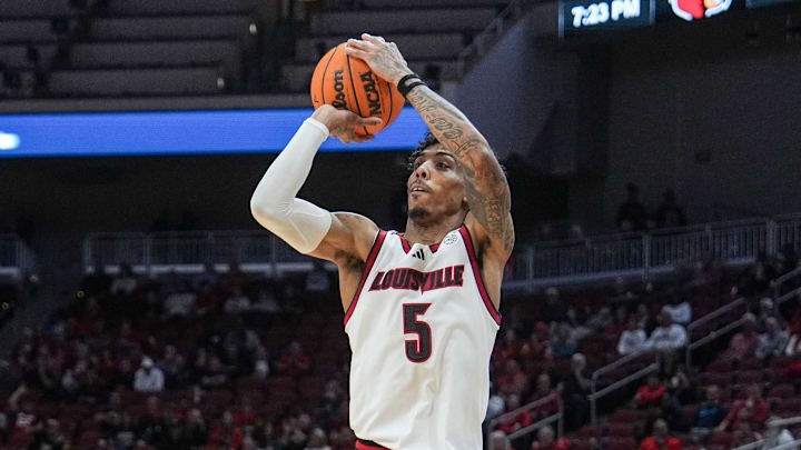 Louisville Cardinals guard Terrence Edwards Jr. (5) scores one of his six three-point shots as the Cards easily defeated Young Harris College 106-59 in the Louisville Cards' first exhibition game at the KFC Yum! Center in downtown Louisville, Ky. Oct. 21, 2024. Edwards finished with 24 points. Louisville Cardinals guard Terrence Edwards Jr. (5) scores one of his six three-point shots as the Cards easily defeated Young Harris College 106-59 in the Louisville Cards' first exhibition game at the KFC Yum! Center in downtown Louisville, Ky. Oct. 21, 2024. Edwards finished with 24 points.