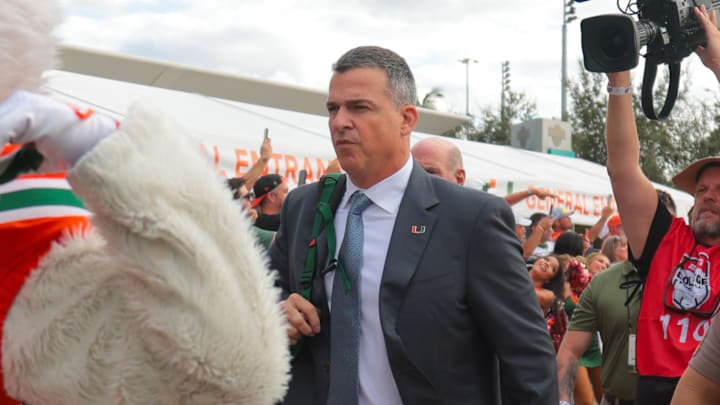Oct 17, 2025; Miami Gardens, Florida, USA; Miami Hurricanes head coach Mario Cristobal during the Hurricane Walk before the game against the Louisville Cardinals at Hard Rock Stadium. Mandatory Credit: Sam Navarro-Imagn Images