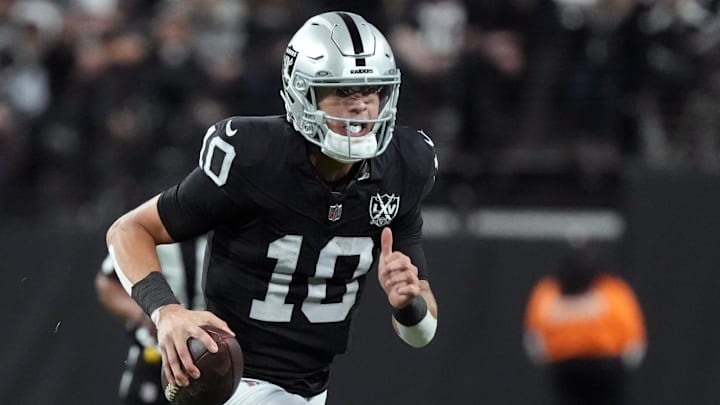 Dec 16, 2024; Paradise, Nevada, USA; Las Vegas Raiders quarterback Desmond Ridder (10) carries the ball against the Atlanta Falcons in the first half at Allegiant Stadium. Mandatory Credit: Kirby Lee-Imagn Images