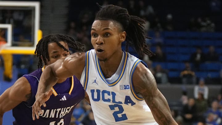 Dec 17, 2024; Los Angeles, California, USA; UCLA Bruins guard Dylan Andrews (2) dribbles the ball against Prairie View A&M Panthers guard Orlando Horton Jr. (12) in the second half at Pauley Pavilion presented by Wescom. Mandatory Credit: Kirby Lee-Imagn Images