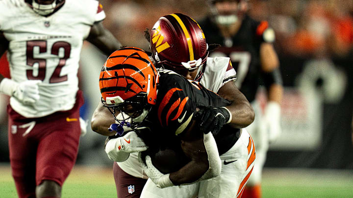 Washington Commanders defensive tackle Jer'Zhan Newton (95) tackles Cincinnati Bengals halfback Zack Moss (31) in the third quarter of the NFL game at Paycor Stadium in Cincinnati on Monday, Sept. 23, 2024.