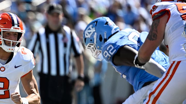 Oct 4, 2025; Chapel Hill, North Carolina, USA; Clemson Tigers quarterback Cade Klubnik (2) with the ball as North Carolina Tar Heels defensive lineman CJ Mims (92) defends in the second quarter at Kenan Stadium. Mandatory Credit: Bob Donnan-Imagn Images
