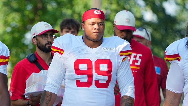 Aug 3, 2026; Kansas City, MO, USA; Kansas City Chiefs   defensive end Felix Anudike-Uzomah (91) and defensive lineman Peter Woods (99) walk down the hill to the fields prior to training camp at Missouri Western University. Mandatory Credit: Denny Medley-Imagn Images
