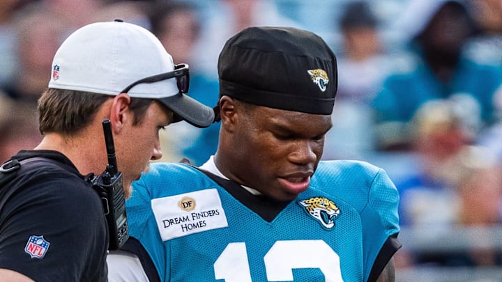 Jacksonville Jaguars wide receiver Travis Hunter (12) asks an equipment man about his helmet before an NFL scrimmage at EverBank Stadium Friday August 1, 2025, in Jacksonville, Fla. [Doug Engle/Florida Times-Union]