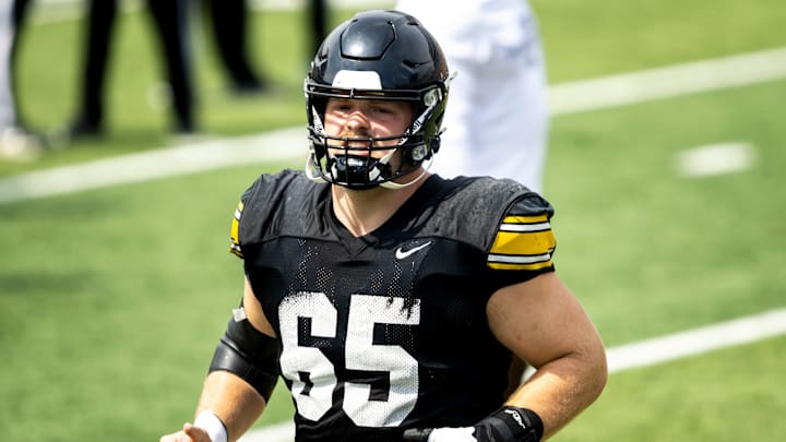 Aug 9, 2025; Iowa offensive lineman Logan Jones (65) warms up during the Hawkeyes Kids Day NCAA football open practice at Kinnick Stadium in Iowa City, Iowa. Mandatory Credit: Joseph Cress for the Des Moines Register Aug 9, 2025; Iowa offensive lineman Logan Jones (65) warms up during the Hawkeyes Kids Day NCAA football open practice at Kinnick Stadium in Iowa City, Iowa. Mandatory Credit: Joseph Cress for the Des Moines Register