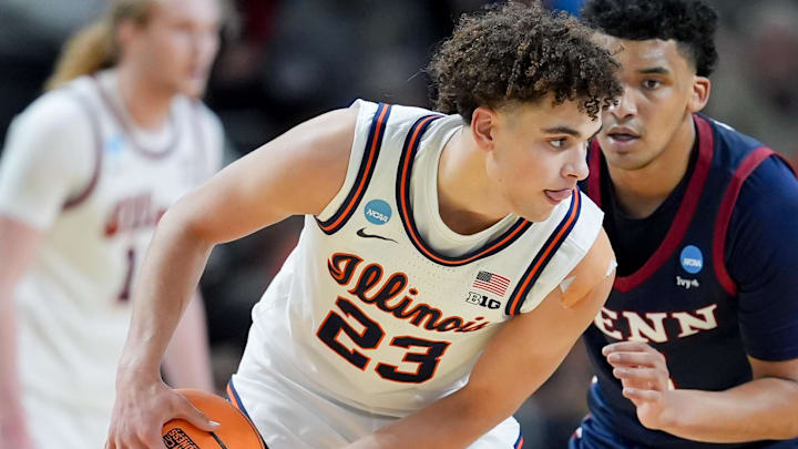 Mar 19, 2026; Greenville, SC, USA; Illinois Fighting Illini guard Keaton Wagler (23) holds the ball Penn Quakers guard Cam Thrower (5) in the first half of a first round game of the men's 2026 NCAA Tournament at Bon Secours Wellness Arena.